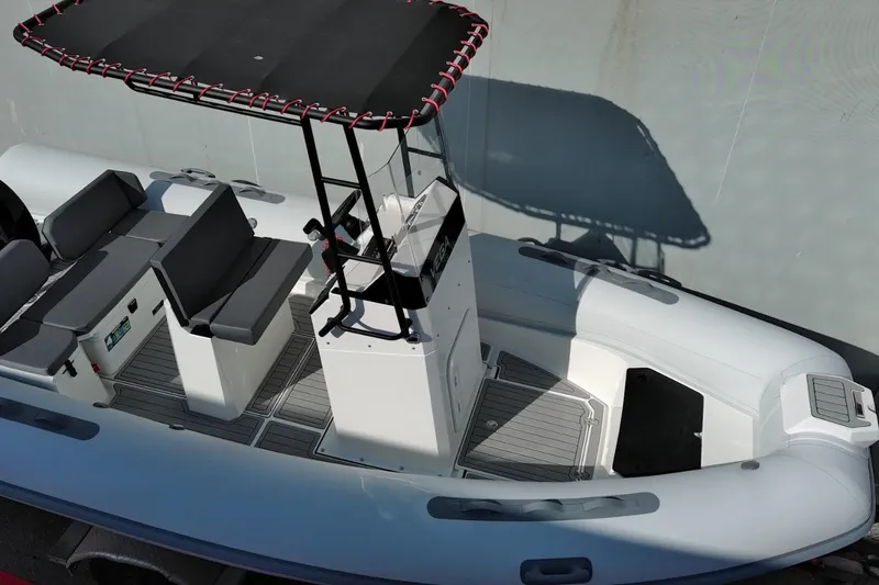 Slide: The Image of 2026 Northstar VEGA 5.4 boat with seating and canopy, viewed from above. - 5