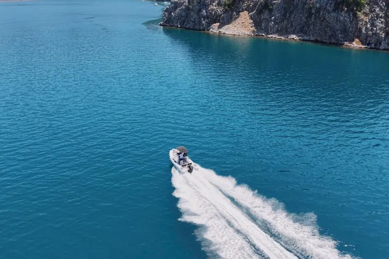 Slide: The Image of Aerial view of Northstar VEGA 5.4 boat cruising on clear blue water, 2026 model. - 6