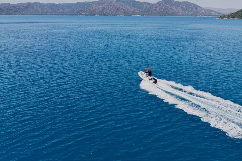 Slide: The Image of Northstar VEGA 5.4 boat cruising on blue ocean, 2026 model, scenic mountain backdrop. - 7