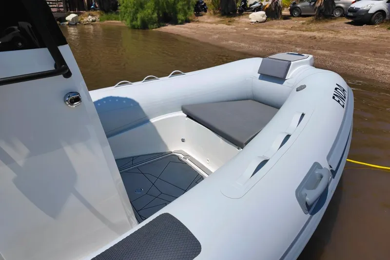 Slide: The Image of 2026 Northstar VEGA 5.4 inflatable boat docked on a sandy shore. - 9