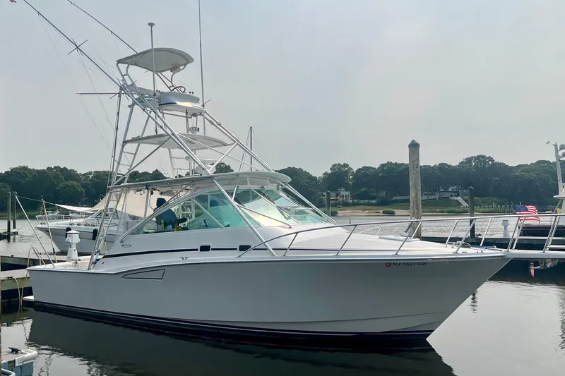 The Image of 2001 Cabo 35 Express yacht docked at a marina, side view. - 0