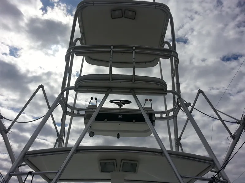 Slide: The Image of 2001 Cabo 35 Express boat tower against a cloudy sky. - 10