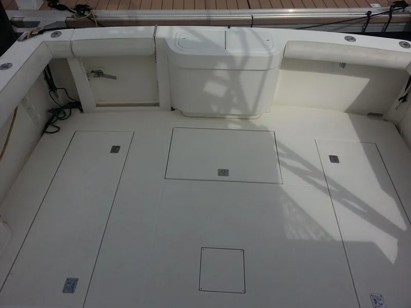 Slide: The Image of 2001 Cabo 35 Express boat deck with storage compartments and seating. - 11