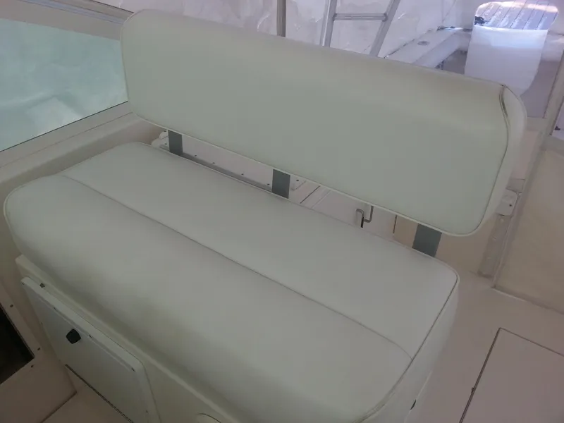 Slide: The Image of White cushioned bench seat on 2001 Cabo 35 Express boat. - 12