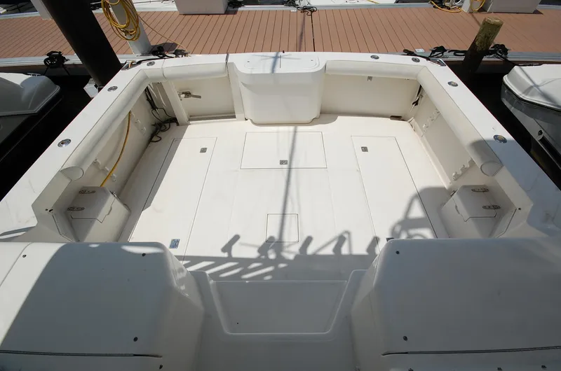 Slide: The Image of 2001 Cabo 35 Express boat deck, spacious and clean, docked at marina. - 14
