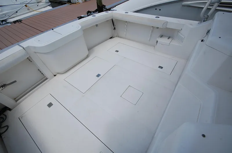 Slide: The Image of 2001 Cabo 35 Express boat deck with storage compartments and seating. - 21