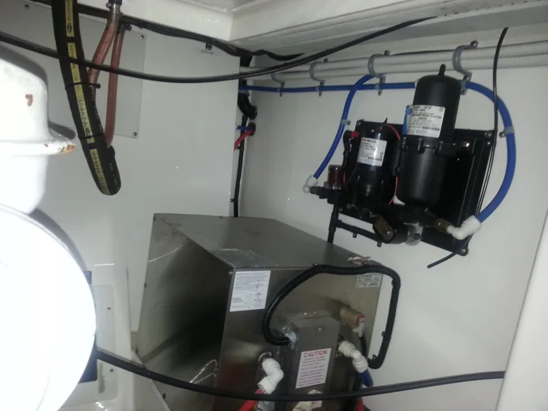 Slide: The Image of Engine room of a 2001 Cabo 35 Express boat, featuring mechanical components and wiring. - 24