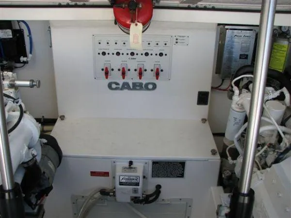Slide: The Image of Engine room of 2001 Cabo 35 Express boat with control panel and equipment. - 25