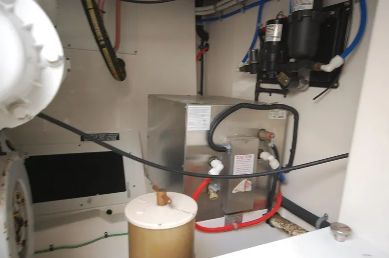 Slide: The Image of Engine room of 2001 Cabo 35 Express boat with mechanical components and wiring. - 30