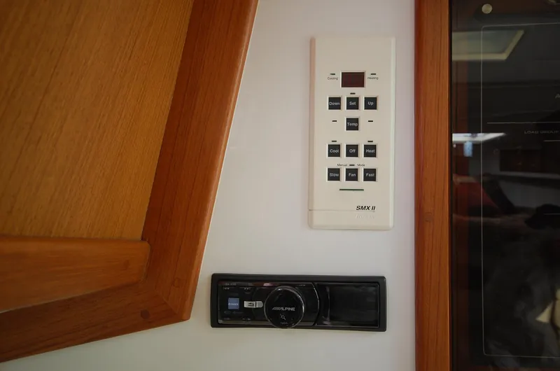 Slide: The Image of Control panel and stereo system inside a 2001 Cabo 35 Express boat. - 32