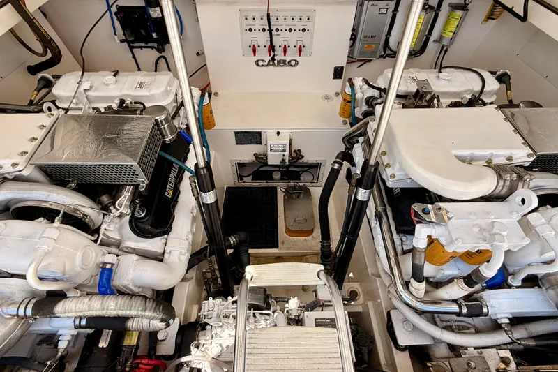 Slide: The Image of Engine room of a 2001 Cabo 35 Express boat, showcasing dual engines and mechanical components. - 38