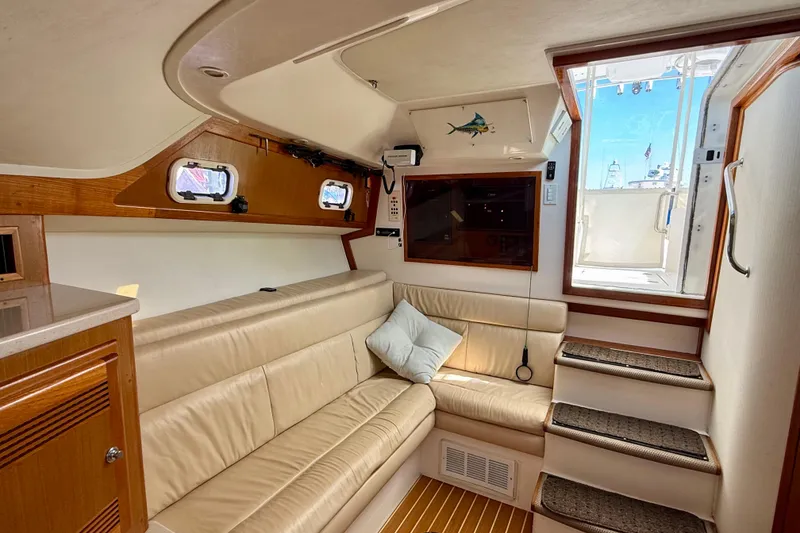 Slide: The Image of Interior of 2001 Cabo 35 Express yacht with beige seating and wooden accents. - 4