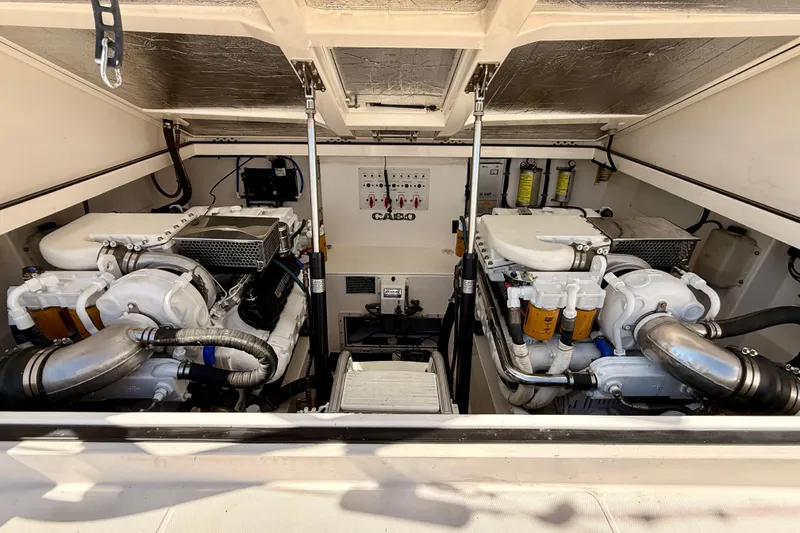 Slide: The Image of Engine room of 2001 Cabo 35 Express boat with dual engines and mechanical components. - 42