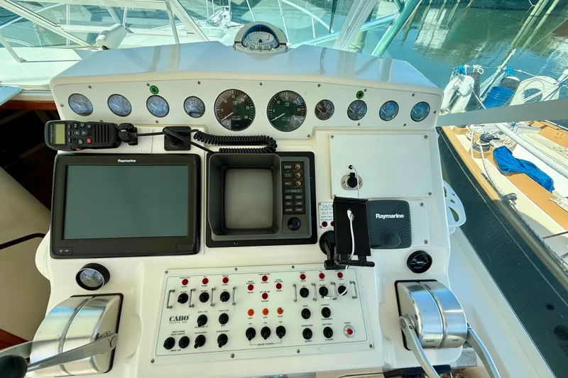 Slide: The Image of Control panel of a 2001 Cabo 35 Express boat with navigation instruments. - 46