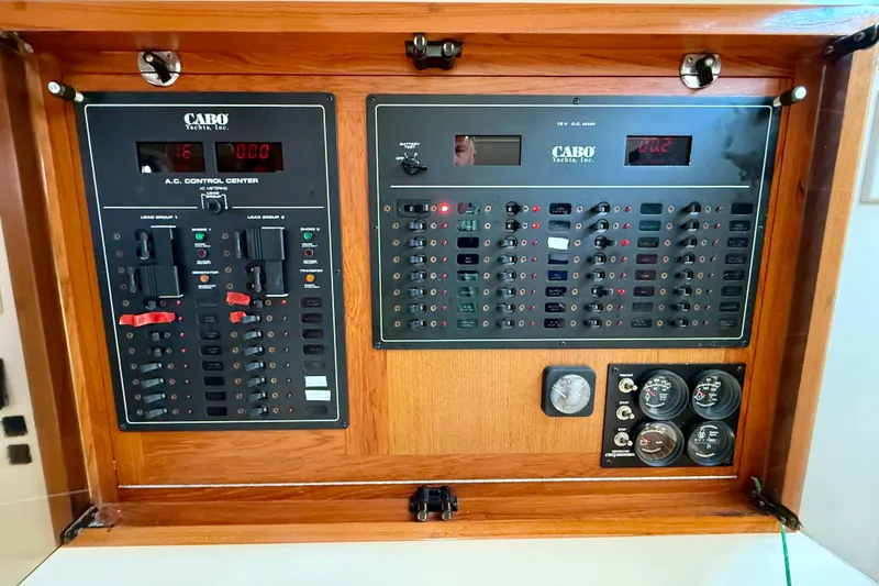 Slide: The Image of Electrical control panel of a 2001 Cabo 35 Express yacht, featuring various switches and gauges. - 47