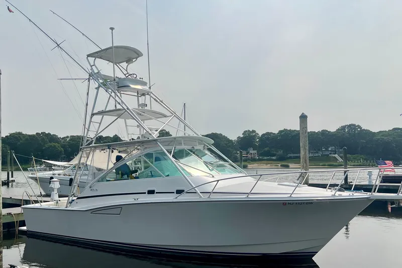 Slide: The Image of 2001 Cabo 35 Express boat docked at marina, clear sky, calm water. - 6