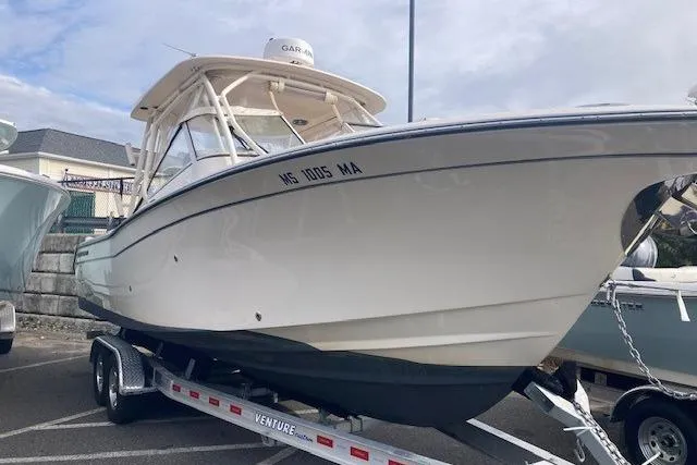 The Image of 2022 Grady-White Freedom 275 boat on trailer, parked outdoors. - 1
