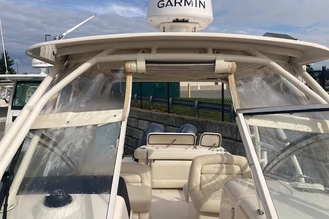 Slide: The Image of 2022 Grady-White Freedom 275 boat with Garmin radar, featuring spacious seating and protective canopy. - 11