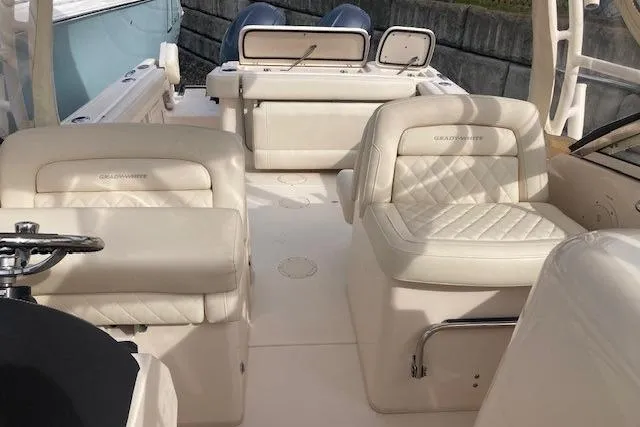 Slide: The Image of 2022 Grady-White Freedom 275 boat interior with luxurious seating and helm. - 12