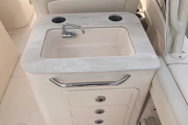 Slide: The Image of 2022 Grady-White Freedom 275 boat sink with storage drawers and faucet. - 13