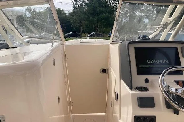 Slide: The Image of 2022 Grady-White Freedom 275 boat cockpit with Garmin navigation system. - 17