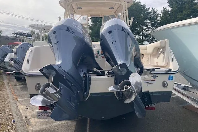 Slide: The Image of 2022 Grady-White Freedom 275 boat with dual outboard engines, docked outdoors. - 3
