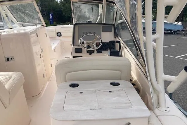 Slide: The Image of 2022 Grady-White Freedom 275 boat interior with steering wheel and Garmin navigation system. - 6
