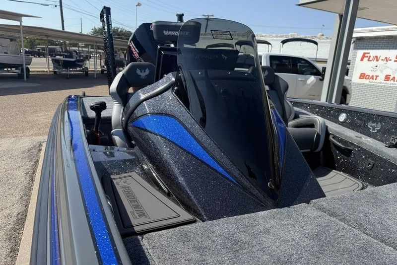 Slide: The Image of 2026 Phoenix 920 Elite X boat with sleek design and blue accents at a dealership. - 10