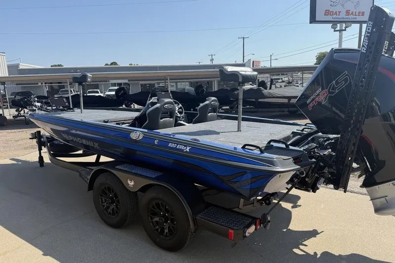 Slide: The Image of 2026 Phoenix 920 Elite X boat with dual axle trailer, displayed at a dealership. - 3