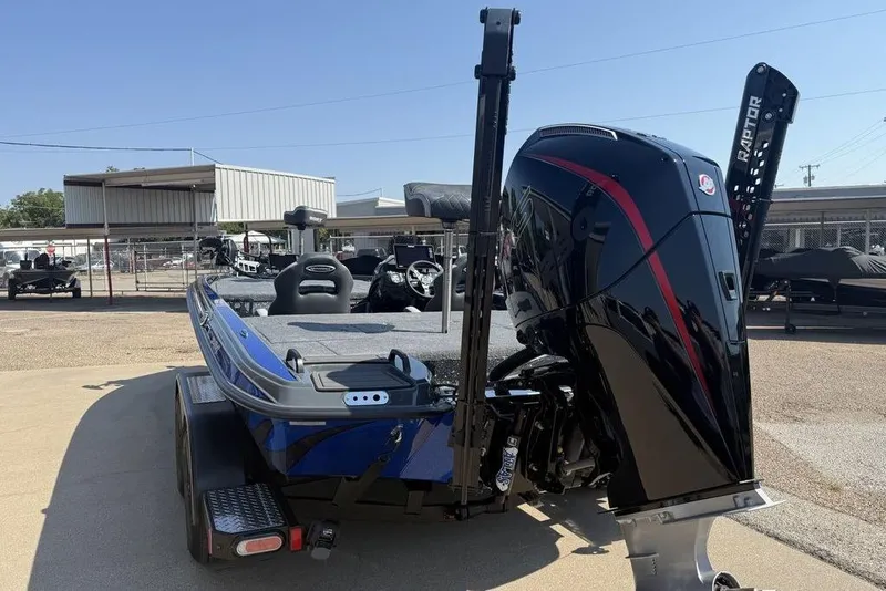 Slide: The Image of 2026 Phoenix 920 Elite X boat with powerful outboard motor in a dealership lot. - 5