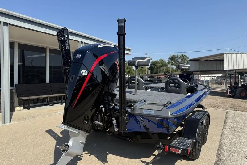 Slide: The Image of 2026 Phoenix 920 Elite X boat with powerful outboard motor, parked outdoors. - 7