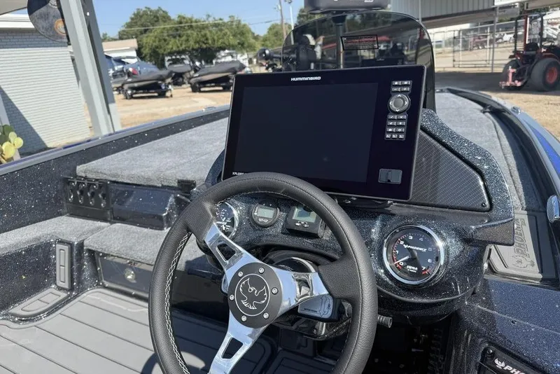 Slide: The Image of 2026 Phoenix 920 Elite X boat dashboard with steering wheel and advanced navigation display. - 9