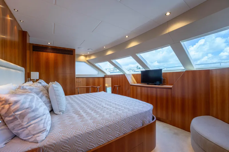 Slide: The Image of Luxurious 2016 Horizon PC60 yacht bedroom with wood paneling and large windows. - 14