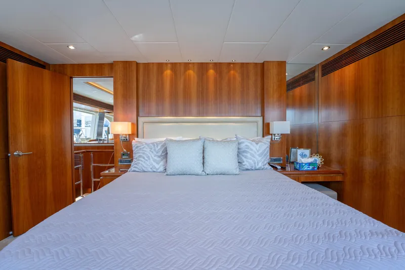 Slide: The Image of Luxurious bedroom interior on 2016 Horizon PC60 yacht with wooden paneling and elegant bedding. - 16