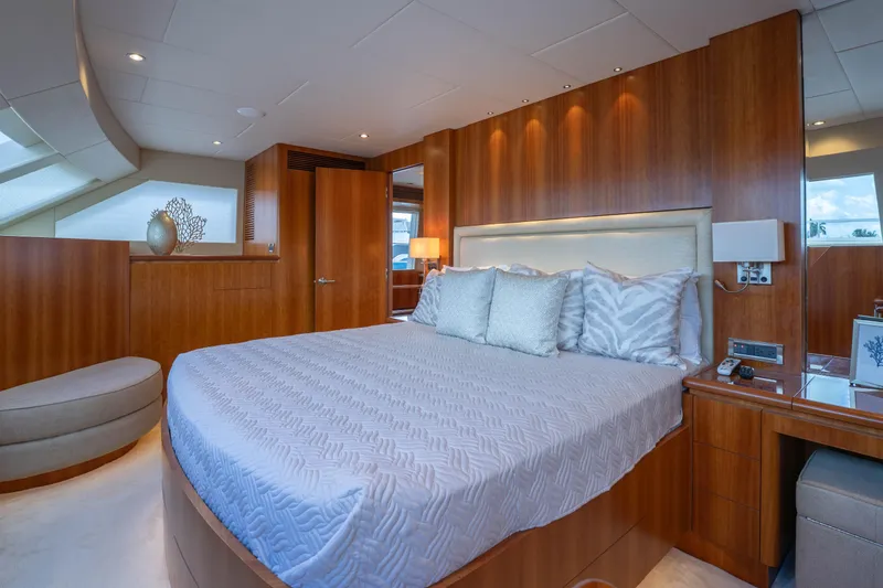 Slide: The Image of Luxurious bedroom interior on 2016 Horizon PC60 yacht with elegant wood paneling and plush bedding. - 17