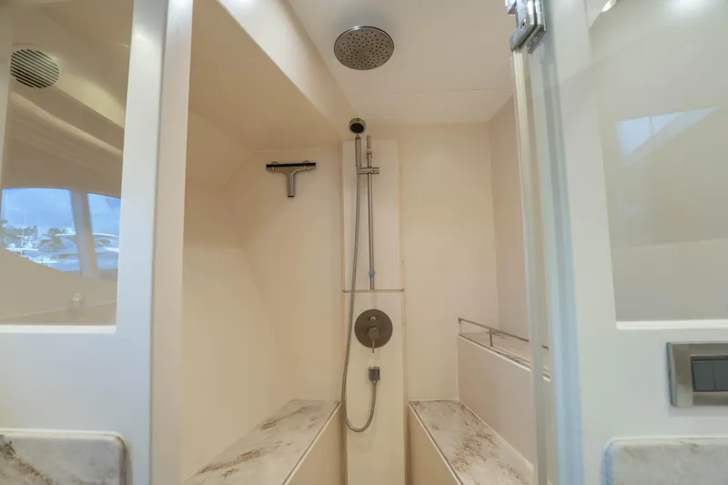 Slide: The Image of Modern shower area in 2016 Horizon PC60 yacht, featuring sleek design and fixtures. - 22