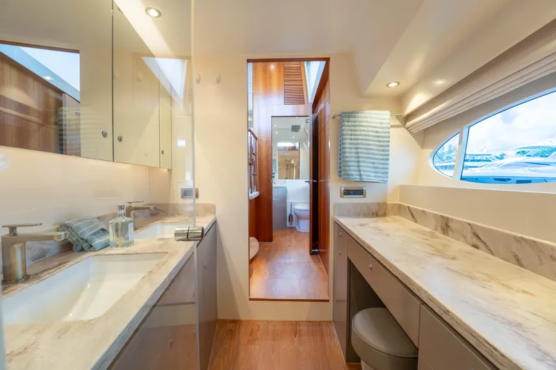 Slide: The Image of Luxurious bathroom interior on 2016 Horizon PC60 yacht, featuring marble countertops and modern fixtures. - 23