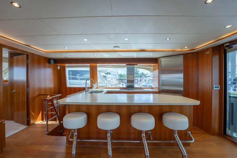 Slide: The Image of Luxurious 2016 Horizon PC60 yacht interior with modern kitchen and bar stools. - 3