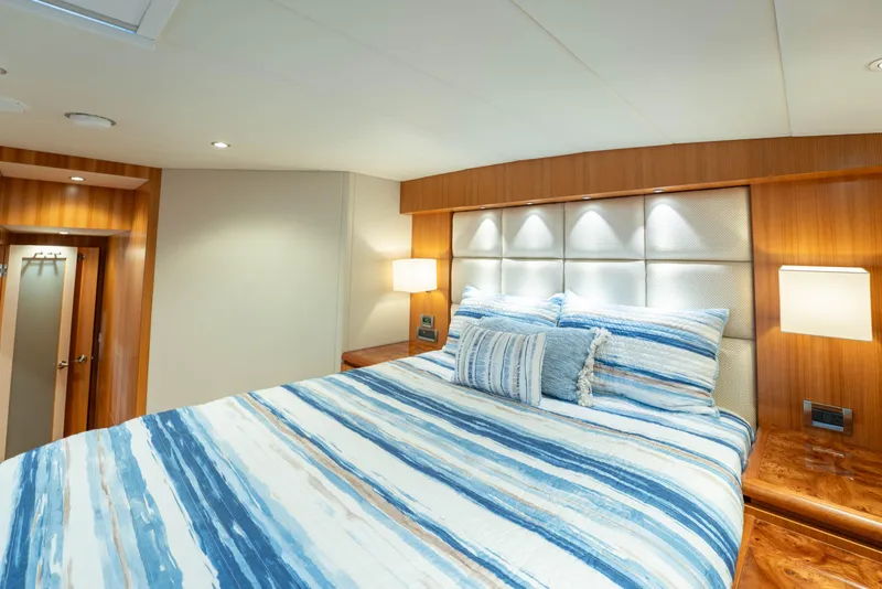 Slide: The Image of Luxurious bedroom interior on 2016 Horizon PC60 yacht with striped bedding and wood accents. - 32