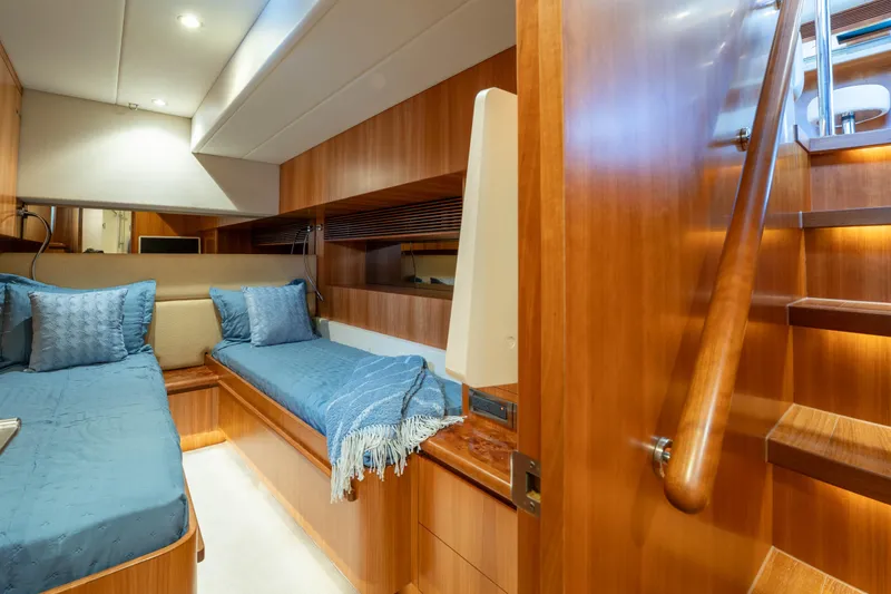 Slide: The Image of Luxurious 2016 Horizon PC60 yacht cabin with twin beds and wooden interior. - 34