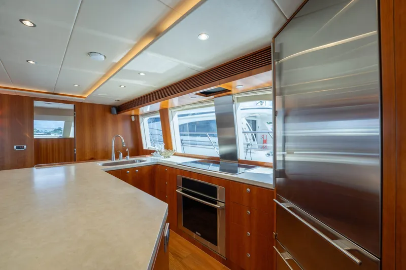 Slide: The Image of Luxurious kitchen interior of 2016 Horizon PC60 yacht with modern appliances and wood finishes. - 4