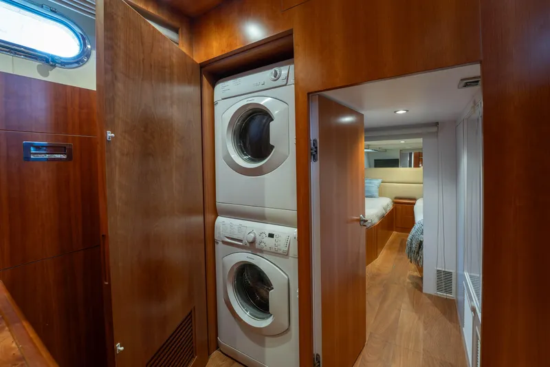 Slide: The Image of Laundry area with stacked washer and dryer in 2016 Horizon PC60 yacht interior. - 40