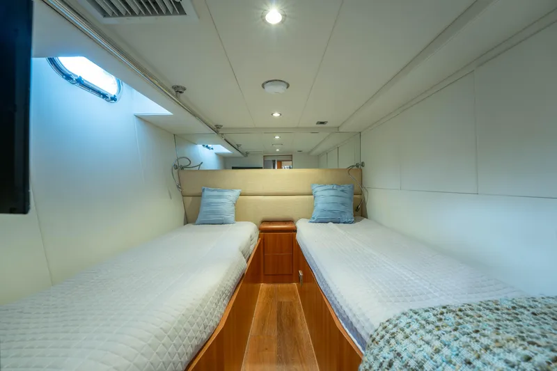 Slide: The Image of Interior of 2016 Horizon PC60 yacht cabin with twin beds and modern decor. - 43