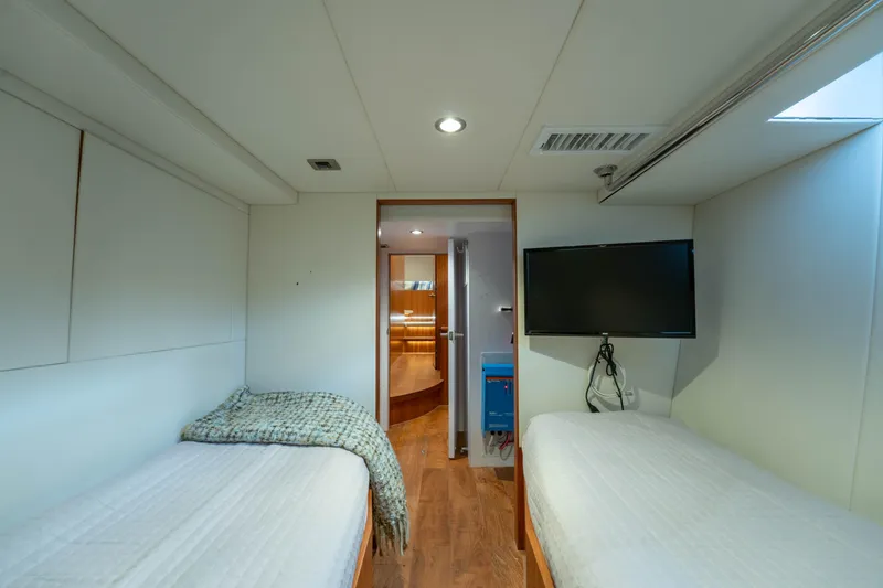 Slide: The Image of Interior of 2016 Horizon PC60 yacht cabin with twin beds and wall-mounted TV. - 44