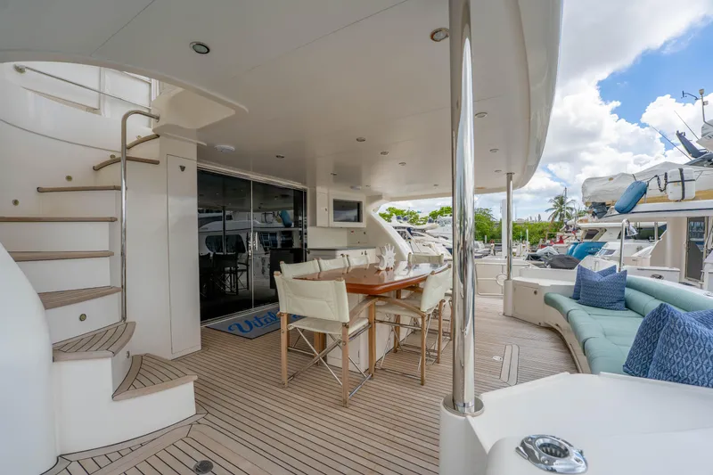 Slide: The Image of Luxurious Horizon PC60 yacht deck with seating, dining area, and spiral staircase, 2016 model. - 47