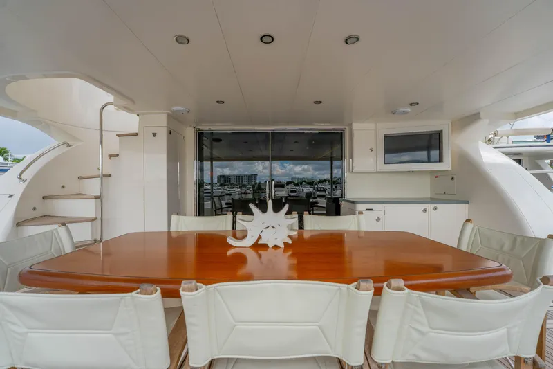 Slide: The Image of Luxurious 2016 Horizon PC60 yacht deck with dining table and seating area. - 48