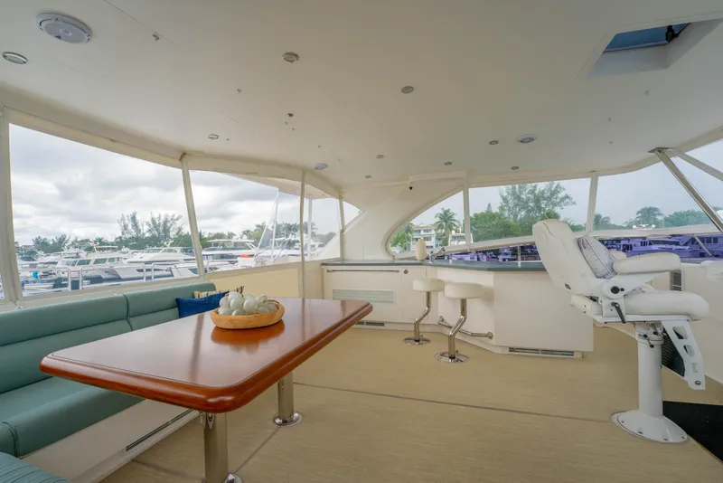 Slide: The Image of Luxurious 2016 Horizon PC60 yacht interior with seating, table, and helm station. - 49