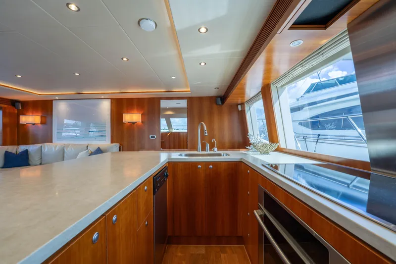 Slide: The Image of Luxurious 2016 Horizon PC60 yacht interior with modern kitchen and elegant wood finishes. - 5