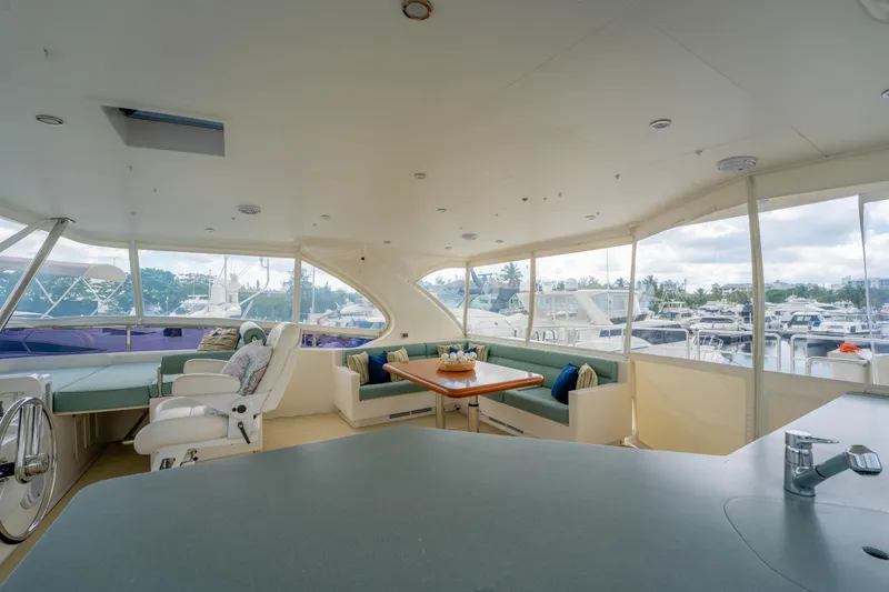 Slide: The Image of Luxurious interior of 2016 Horizon PC60 yacht with spacious seating and marina view. - 50