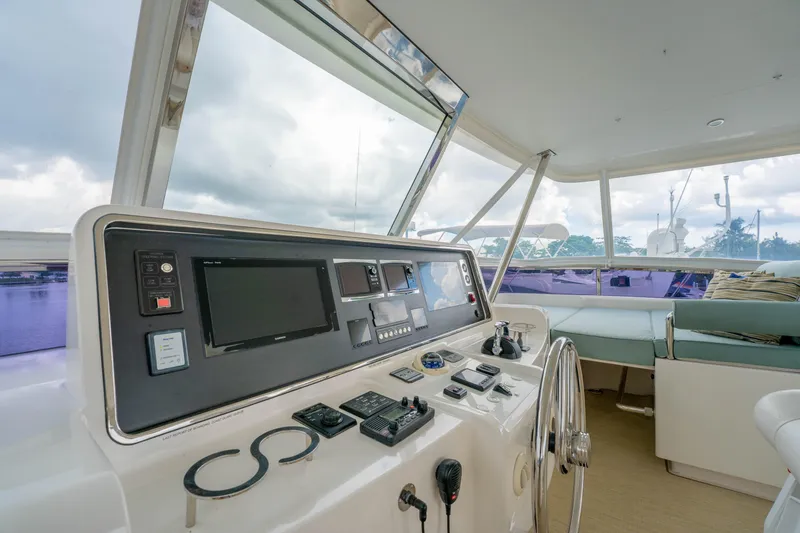 Slide: The Image of Helm of 2016 Horizon PC60 yacht with modern navigation controls and panoramic view. - 51